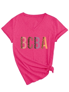 Detail of fuchsia V-neck T-shirt featuring BCBA leopard print patchwork and a side knot