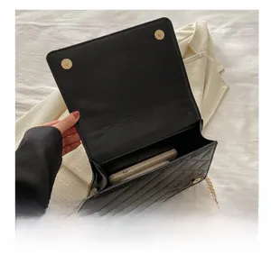 Interior view of black quilted chain bag showing capacity for daily essentials
