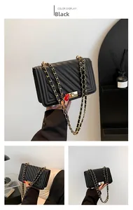 Detail of black V-quilted chain bag showing the golden twist lock and leather chain strap