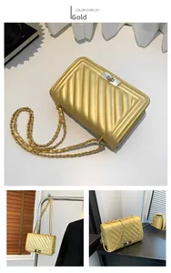 Detailed view of golden quilted handbag showing metallic chain strap and twist-lock clasp