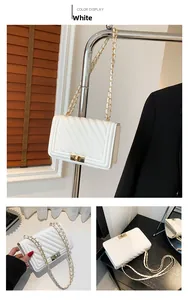Close-up showing V-quilted texture and gold metal lock on the white flap bag