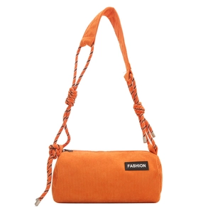 Orange corduroy cylinder crossbody bag with textured fabric and woven shoulder strap