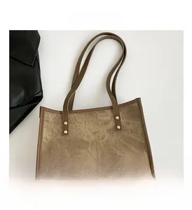 Detail view of large retro tote bag with brown vintage fabric and gold rivet studs