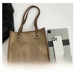 Detailed size comparison of retro brown leather tote bag with iPad and smartphone