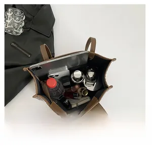 Top view of large brown tote bag showing spacious interior with tablet and daily essentials