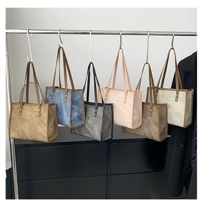 Detail view of large retro tote bags in six colors with vintage marbled texture and rivets