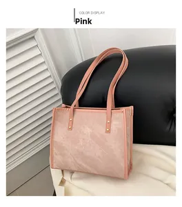 Detail of pink tote bag with cloudy matte texture and gold rivet reinforcements