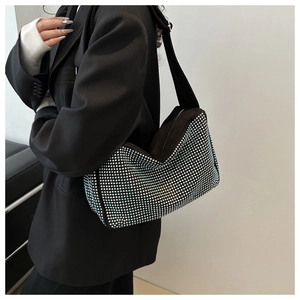 Détail du sac polochon noir avec strass dégradés bleu et argent et large bandoulière
