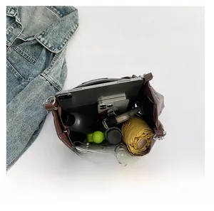 Interior view of brown leather tote bag showing large capacity for tablet and daily items