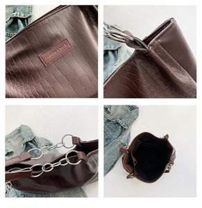 Detail shots of burgundy faux leather tote bag with crocodile texture and silver chain rings
