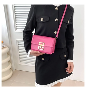 Hot pink square crossbody bag featuring a shiny leather finish and gold metal buckle