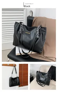Detail view of black crocodile pattern tote bag with decorative silver metal chain links