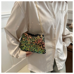 Detail of trendy sequins shoulder bag with colorful iridescent shine and gold chain strap