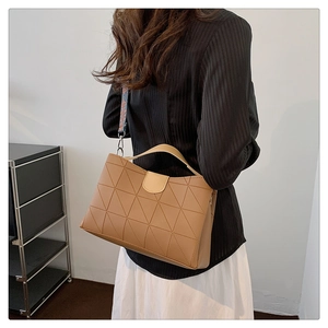 Fashionable brown leather bucket bag with geometric stitching and ethnic style wide strap