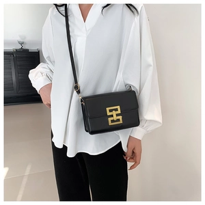 Classic black leather crossbody bag with golden H-shaped clasp and adjustable strap