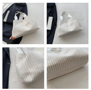 Detail view showing corduroy texture and sturdy handles of white minimalist tote bag