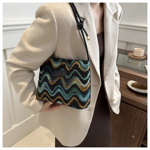 Retro colorful wavy knit wool shoulder bag worn by model in a cozy indoor setting