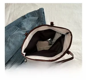 Spacious interior of white tote bag showing storage for umbrella and long wallet