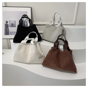 Corduroy tote bags in four colors arranged on a stylish display stand for women