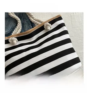 Detail of black and white striped tote bag with thick rope handles and canvas texture