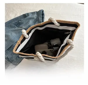 Macro view of checkered canvas tote bag interior showing large capacity and zipper pocket