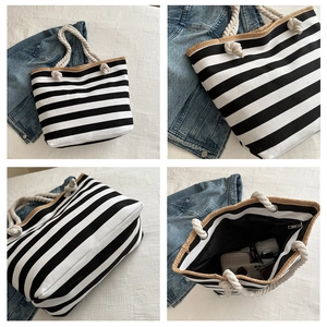 Detailed view of striped canvas tote with straw trim, rope handles and large interior
