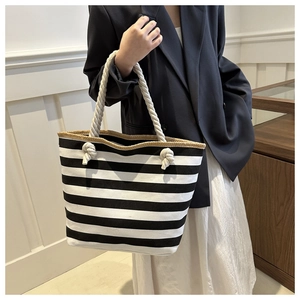 Detail of canvas tote bag with black and white stripes and thick cotton rope handles