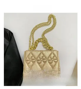 Detail of champagne gold sequin crossbody bag with quilted pattern and metal chain strap