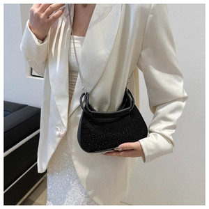 Detail of black rhinestone crescent bag with chain strap and elegant handle