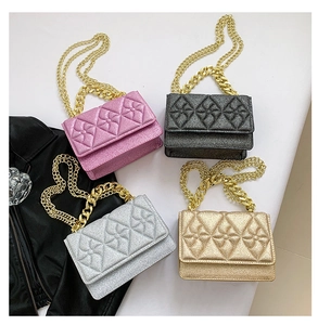 Flat lay of shimmering sequin crossbody bags in four colors with gold chain straps