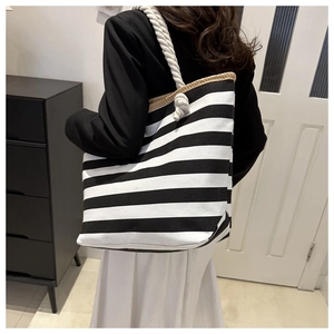 Close-up of black and white striped canvas tote bag with thick cotton rope handles