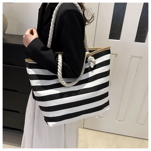 Detail of black and white striped canvas tote with soft cotton rope handles for women