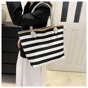 Detail of canvas tote bag showing black and white stripes and thick cotton rope handle