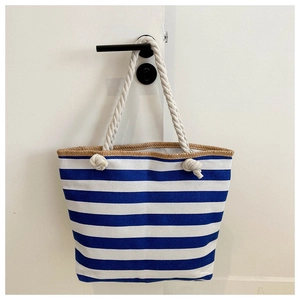 Detail of blue and white striped canvas tote with woven trim and cotton rope handle