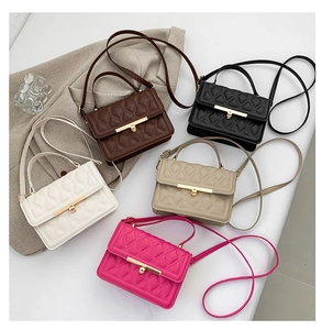 Flat lay of quilted crossbody bags in five colors with metallic lock details