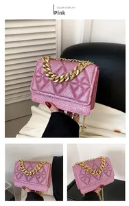 Detail showing pink glitter quilted crossbody bag with gold chain strap and texture
