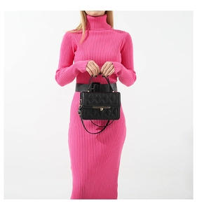 Chic black quilted handbag with gold hardware styled on a pink knit dress