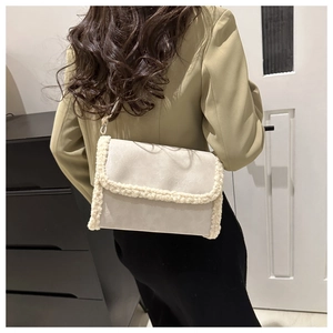 Detail of off-white faux leather crossbody bag with cozy faux shearling trim and chain strap