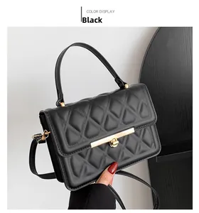 Detail of black quilted leather handbag featuring elegant gold clasp and chain strap