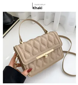 Detailed close-up of khaki quilted leather bag with elegant golden metal lock