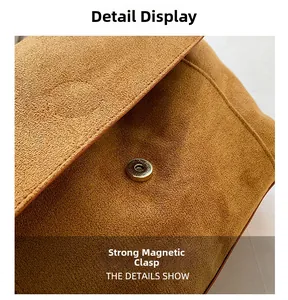 Detail view of the strong silver magnetic closure on a brown frosted leather handbag
