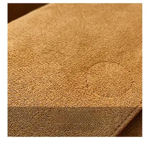 Macro detail of brown matte suede leather with high-quality circular stitching texture
