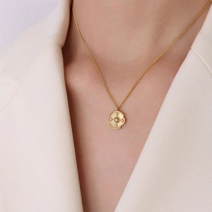 Irregular round pendant necklace with compass design and cubic zirconia on gold chain