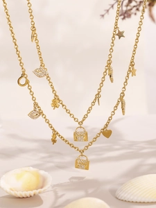 Detailed view of 18K gold plated charms featuring zircons, hearts and clovers on necklaces