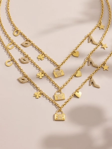 Detailed view of 18k gold plated multi-layer necklace with handbag and zircon charms