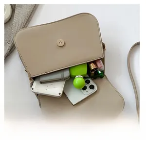 Top view of beige shoulder bag interior showing large capacity for phone and cosmetics