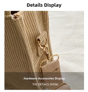 Detailaufnahme der goldenen Metallhaken und des beigen Cord-Tragegurts der Handtasche
