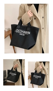 Detail view of large black canvas tote bag with white LOCOHAWAII AOLHA letter print