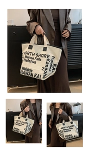 Detail of white canvas tote bag featuring black Hawaii typography and reinforced handles
