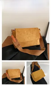 Detail of brown faux suede tote bag featuring a wide shoulder strap and matte texture